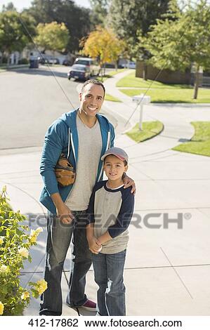 Portrait of smiling father and son in driveway View Large Photo Image Stock Image - Portrait of smiling father and son in driveway. Fotosearch