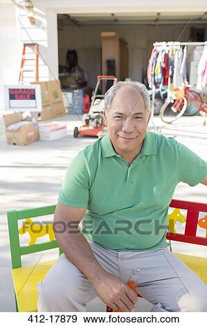 Portrait of smiling man at garage sale View Large Photo Image Stock Photo - Portrait of smiling man at garage sale. Fotosearch