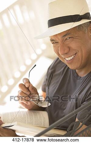 Portrait of smiling man reading book View Large Photo Image Stock Photo - Portrait of smiling man reading book. Fotosearch