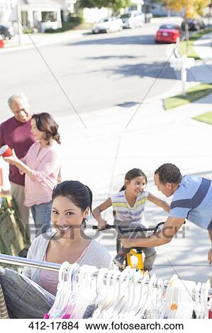 Picture - Portrait of smiling woman shopping at yard sale. Fotosearch