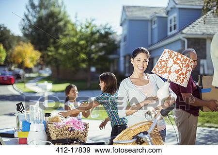 Portrait of smiling woman with lamp at yard sale View Large Photo Image Stock Photo - Portrait of smiling woman with lamp at yard sale. Fotosearch