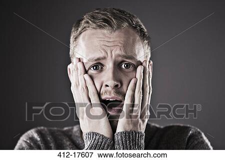 Portrait of surprised man with head in hands View Large Photo Image Stock Photo - Portrait of surprised man with head in hands. Fotosearch
