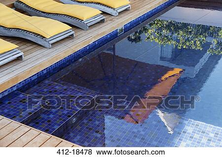 Reflection of umbrella in luxury swimming pool View Large Photo Image Stock Photo - Reflection of umbrella in luxury swimming pool. Fotosearch