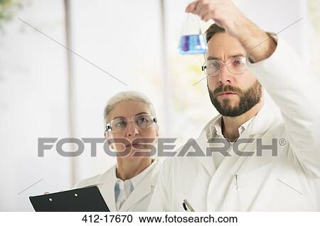 Scientists examining liquid View Large Photo Image Stock Image - Scientists examining liquid. Fotosearch