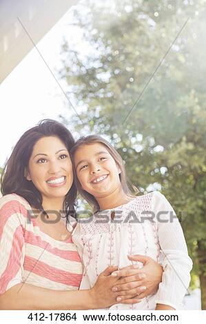 Smiling mother and daughter outdoors View Large Photo Image Picture - Smiling mother and daughter outdoors. Fotosearch