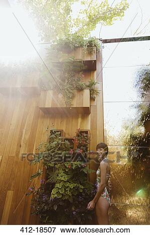 Smiling woman in sunny courtyard View Large Photo Image Stock Photo - Smiling woman in sunny courtyard. Fotosearch