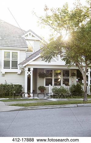 Stock Photo - Sun shining over house. Fotosearch