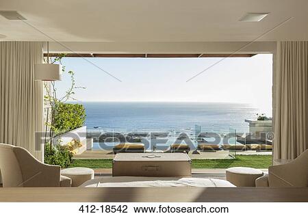 Sunny bedroom and patio overlooking ocean View Large Photo Image Stock Image - Sunny bedroom and patio overlooking ocean. Fotosearch
