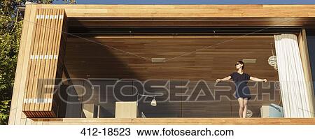 Woman standing on luxury balcony View Large Photo Image Stock Image - Woman standing on luxury balcony. Fotosearch