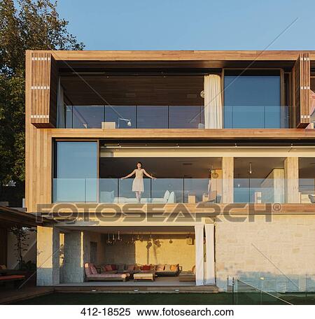Woman standing on luxury balcony View Large Photo Image Stock Photography - Woman standing on luxury balcony. Fotosearch