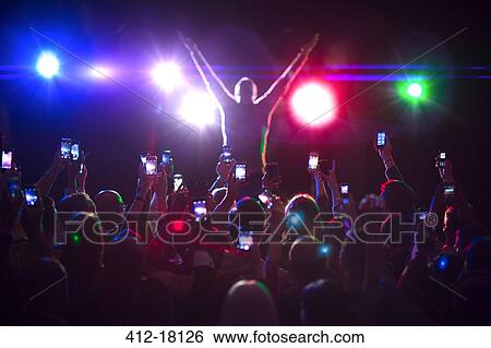 Audience photographing musician on stage View Large Photo Image Stock Photograph - Audience photographing musician on stage. Fotosearch
