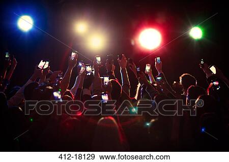 Stock Photo - Audience using camera phones at concert. Fotosearch