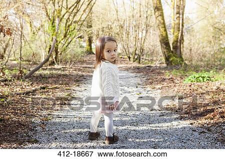 Baby girl walking on gravel path View Large Photo Image Stock Photo - Baby girl walking on gravel path. Fotosearch