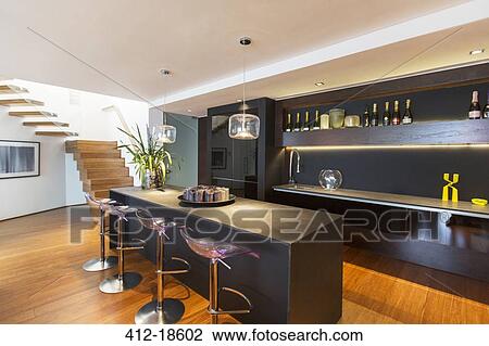 Stock Image - Bar stools and countertop in modern lounge. Fotosearch