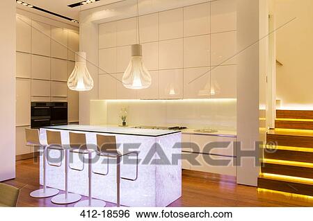 Bar stools and lighting in modern kitchen View Large Photo Image Stock Photograph - Bar stools and lighting in modern kitchen. Fotosearch