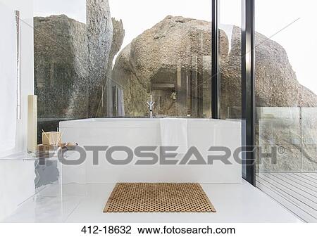Stock Image - Bathtub and glass walls in modern bathroom. Fotosearch