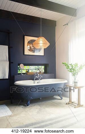 Bathtub and light fixture in modern bathroom View Large Photo Image Picture - Bathtub and light fixture in modern bathroom. Fotosearch