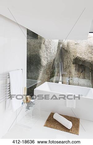 Stock Photograph - Bathtub and rock feature of modern bathroom. Fotosearch