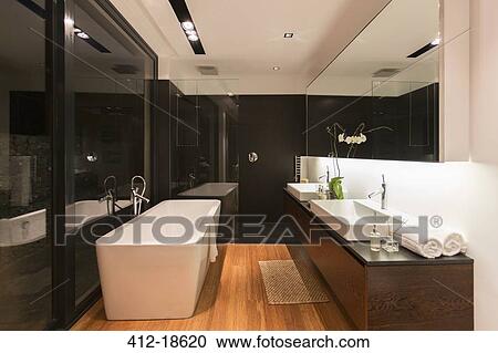 Stock Image - Bathtub and sinks in modern bathroom. Fotosearch