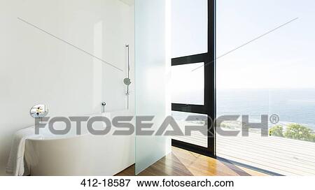 Bathtub and sliding glass door of modern house View Large Photo Image Stock Photo - Bathtub and sliding glass door of modern house. Fotosearch