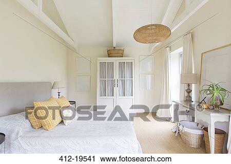 Bed and cabinet in bedroom of rustic house View Large Photo Image Stock Image - Bed and cabinet in bedroom of rustic house. Fotosearch