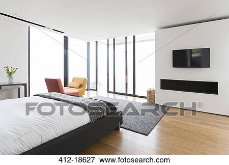 Bed and sliding glass doors in modern bedroom View Large Photo Image Stock Photo - Bed and sliding glass doors in modern bedroom. Fotosearch
