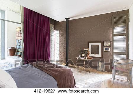 Bed, side table and pictures in rustic bedroom View Large Photo Image Stock Photo - Bed, side table and pictures in rustic bedroom. Fotosearch