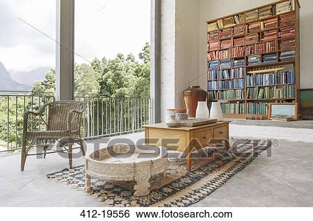 Bookcase and coffee table in modern house View Large Photo Image Stock Photograph - Bookcase and coffee table in modern house. Fotosearch
