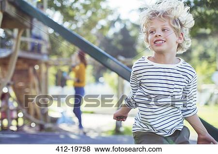 Stock Photo - Boy playing on play ground. Fotosearch