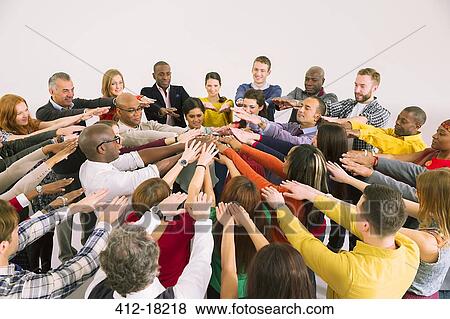 Stock Photo - Business people connecting hands in huddle. Fotosearch