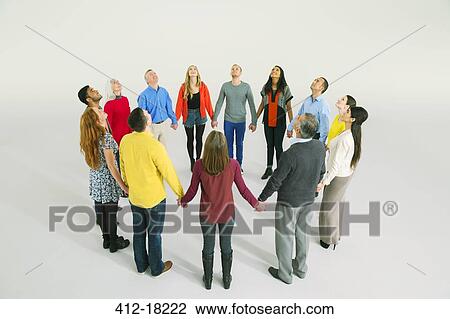 Business people holding hands in circle View Large Photo Image Stock Image - Business people holding hands in circle. Fotosearch