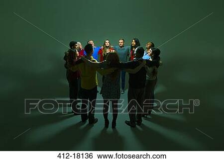 Business people in circle around bright light View Large Photo Image Stock Photograph - Business people in circle around bright light. Fotosearch