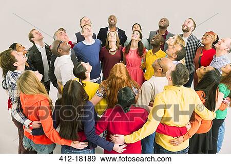 Stock Photo - Business people looking up in huddle. Fotosearch