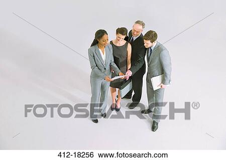 Stock Photograph - Business people reviewing paperwork. Fotosearch