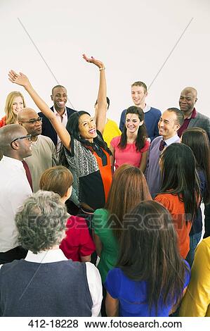 Stock Photo - Business people watching cheering woman. Fotosearch