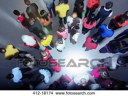 Business people with backs turned on bright light View Large Photo Image Picture - Business people with backs turned on bright light. Fotosearch