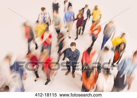 Stock Photography - Businessman standing out from the crowd. Fotosearch