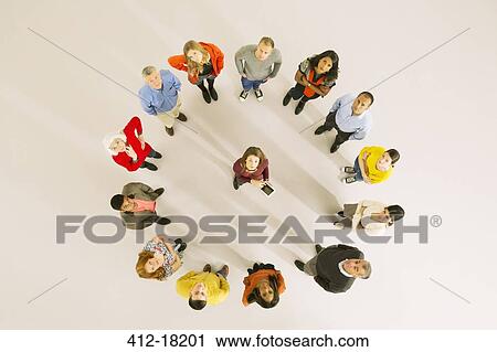 Businesswoman with digital tablet surrounded by co-workers View Large Photo Image Stock Image - Businesswoman with digital tablet surrounded by co-workers. Fotosearch