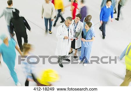 Bustling crowd around doctors and nurses View Large Photo Image Stock Photo - Bustling crowd around doctors and nurses. Fotosearch