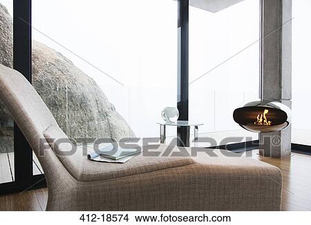 Chair and fireplace in modern living room View Large Photo Image Picture - Chair and fireplace in modern living room. Fotosearch