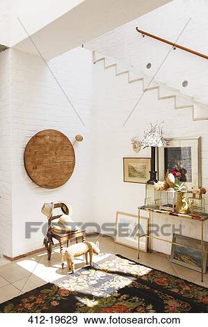 Stock Photo - Chair and wall hanging in rustic house. Fotosearch