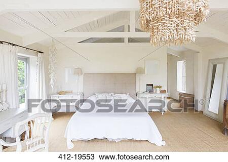 Chandelier and bed in rustic bedroom View Large Photo Image Stock Image - Chandelier and bed in rustic bedroom. Fotosearch