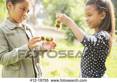 Children examining plants outdoors View Large Photo Image Stock Photography - Children examining plants outdoors. Fotosearch