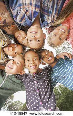 Children huddled together outdoors View Large Photo Image Stock Photo - Children huddled together outdoors. Fotosearch