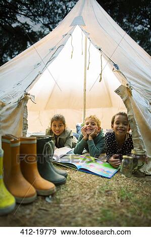 Children smiling in tent at campsite View Large Photo Image Stock Photo - Children smiling in tent at campsite. Fotosearch