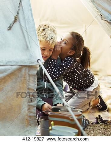 Children whispering in tent at campsite View Large Photo Image Stock Photo - Children whispering in tent at campsite. Fotosearch