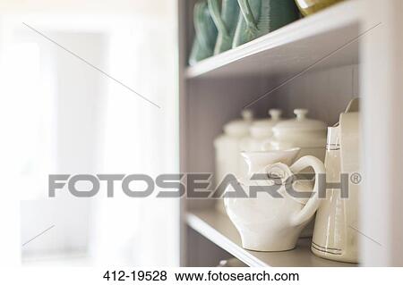 Close up of ceramics on kitchen shelf View Large Photo Image Stock Photo - Close up of ceramics on kitchen shelf. Fotosearch