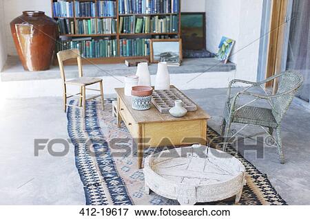 Stock Photo - Coffee table and chairs in rustic study. Fotosearch