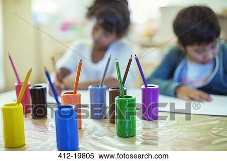 Colored pencils on desk in classroom View Large Photo Image Stock Photography - Colored pencils on desk in classroom. Fotosearch