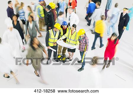 Stock Photo - Construction workers viewing blueprints among crowd. Fotosearch